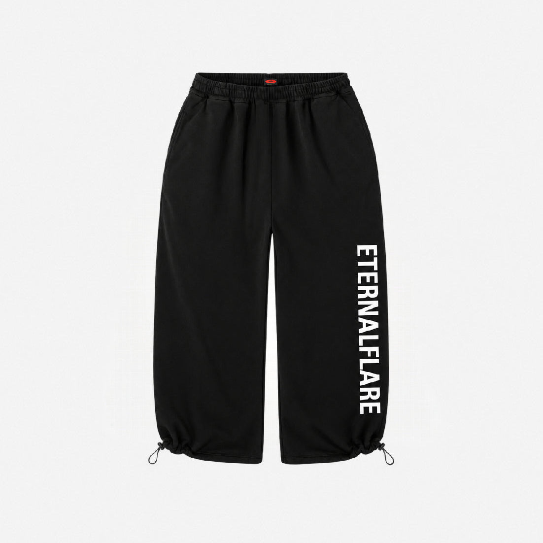Black jogger-style pants with an elastic waistband, drawstring ankle cuffs, and vertical white 'ETERNALFAIRE' text printed on the left leg, shown against a plain light gray background.